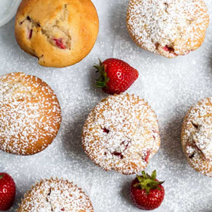 Fresh Strawberry Muffins with powdered sugar by themerchantbaker.com