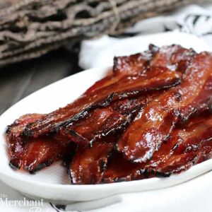 brown sugar maple glazed bacon piled on a white oval plate