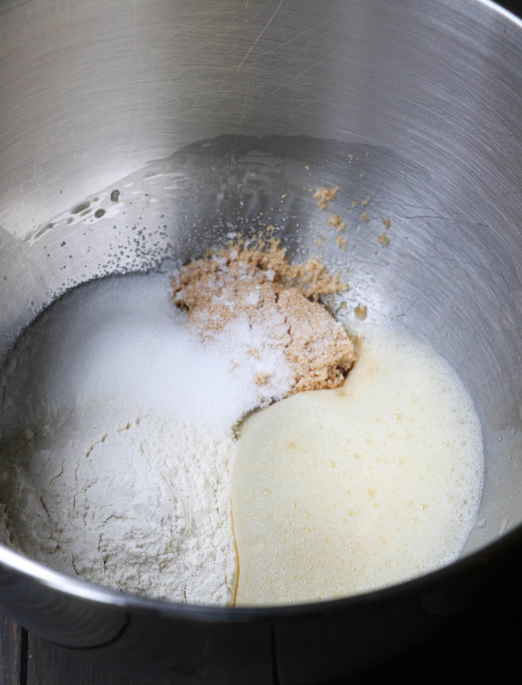flour and sugars sitting in a bowl next to foamy egg mixture