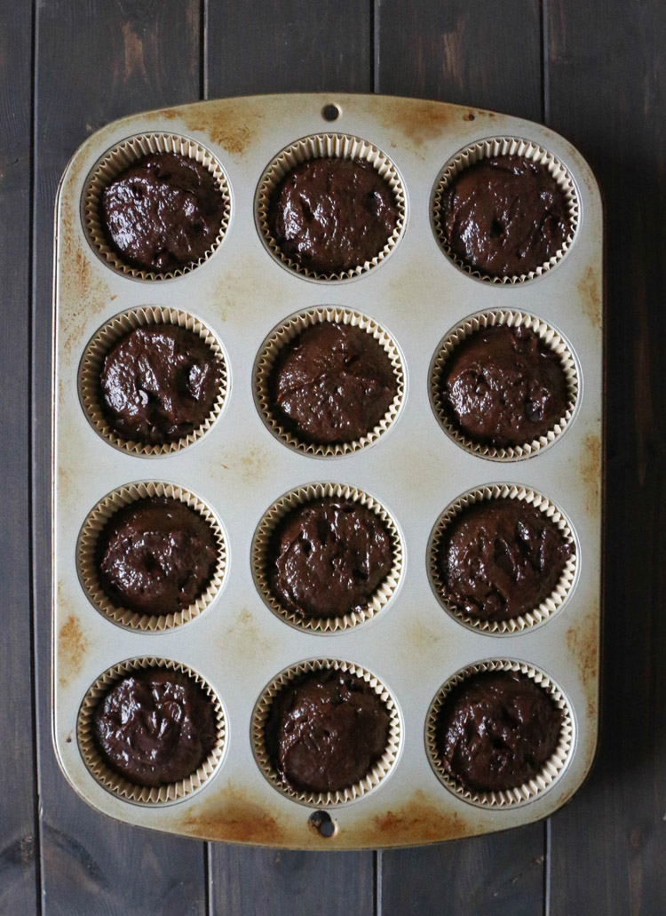 overhead view of chocolate muffin batter in a 12 cup muffin pan