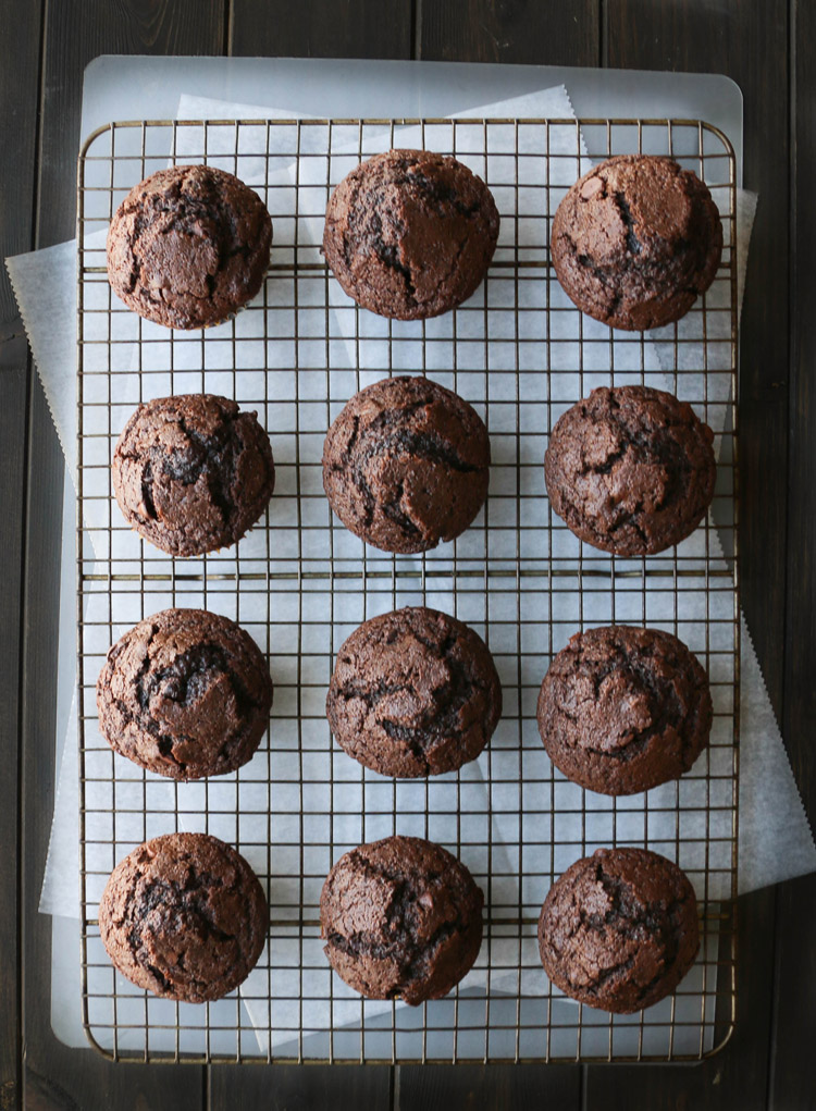 Overhead view of baked chocolate muffins on a wire grid cooling rack