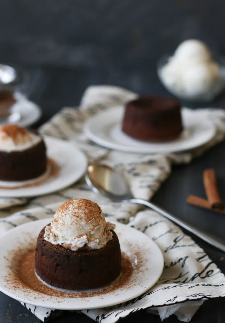 cinnamon on top of a spicy molten chocolate lava cake that has a scoop of vanilla ice cream on top