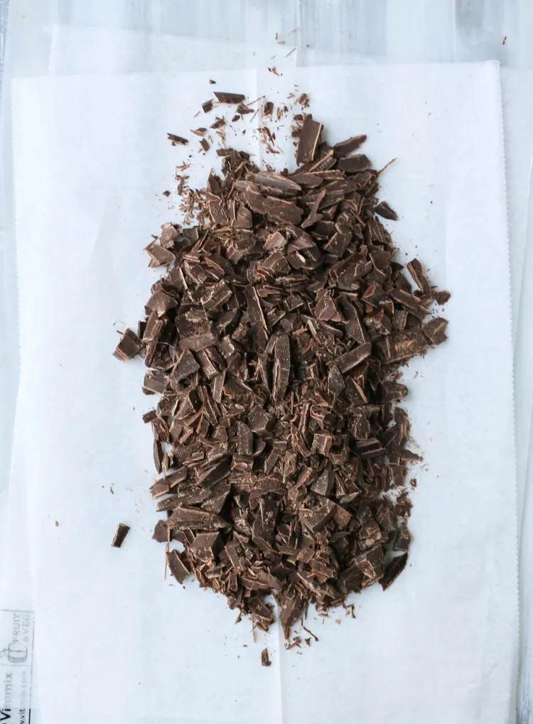 Chopped chocolate on parchment paper.