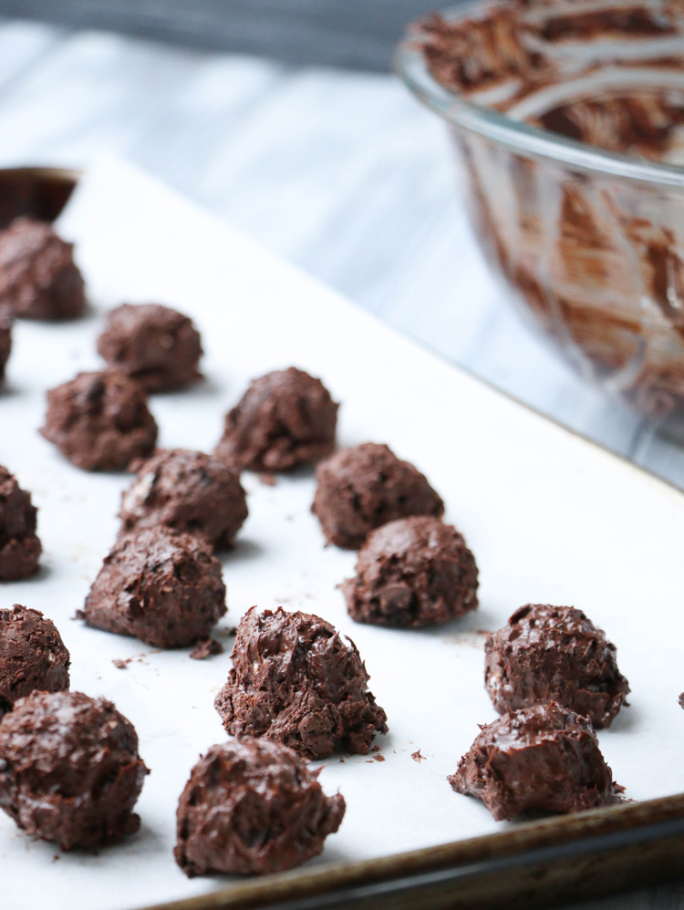 Peppermint Cookie Clusters scooped onto a parchment lined baking sheet
