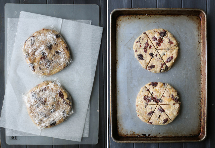 An overhead photo of two discs of wrapped and unwrapped Cherry Almond Scones dough on a baking sheet.