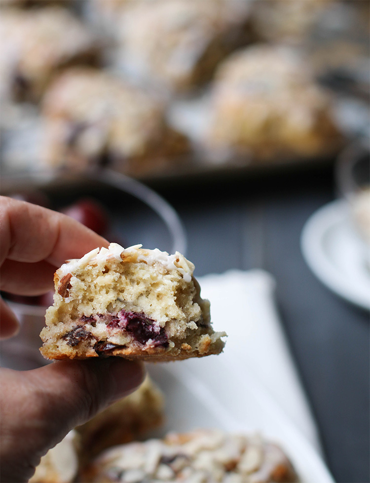 hand holding a piece of Cherry Almond Scone and showing the inside texture