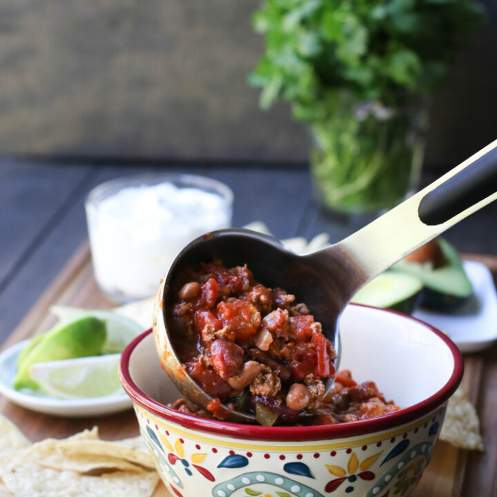 Pouring Turkey Chili into bowl from ladle.