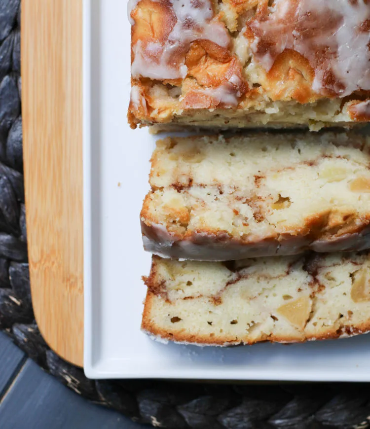 Top view of a loaf of Apple Fritter Bread with 2 slices cut and facing up
